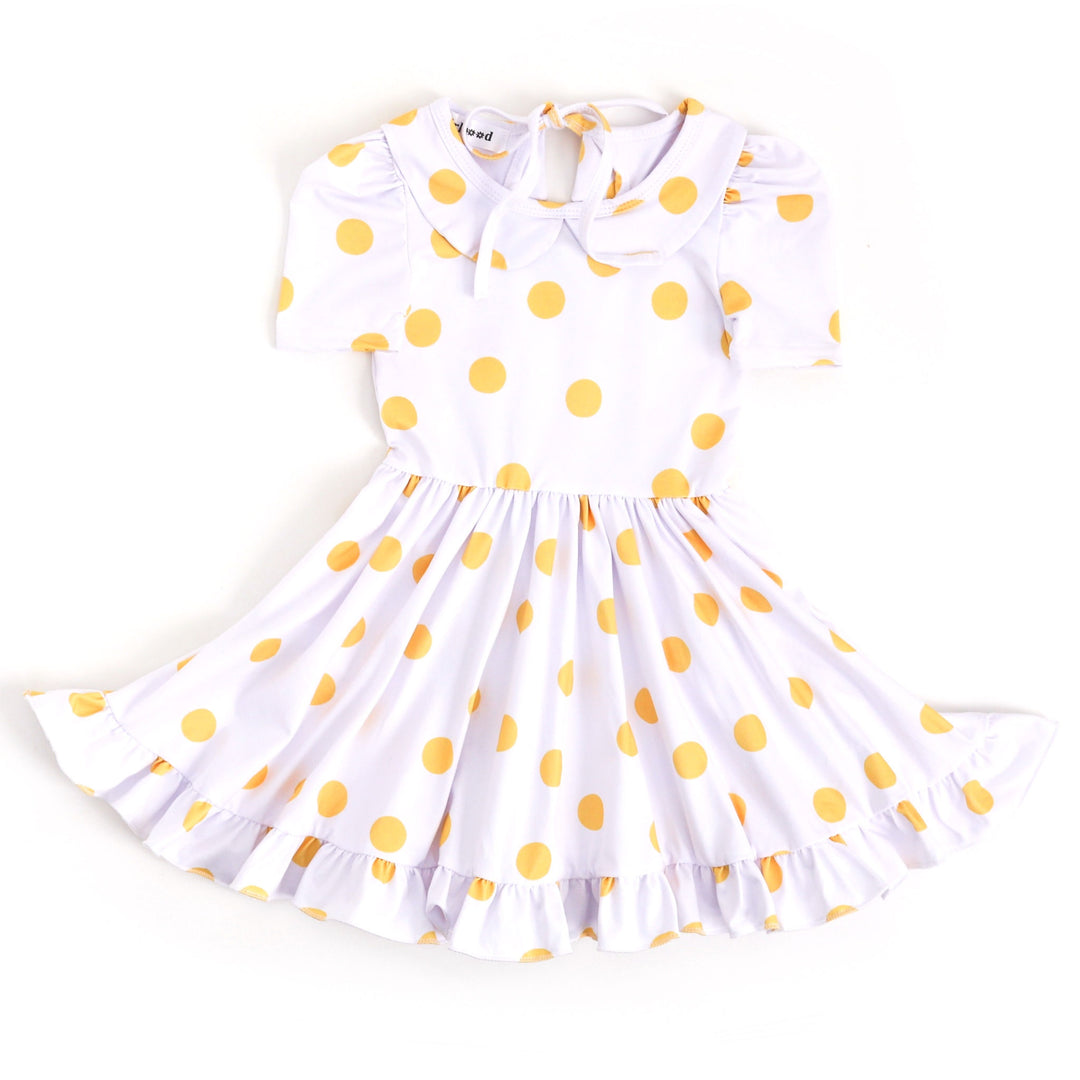 little girls white twirl dress with big yellow polka dots
