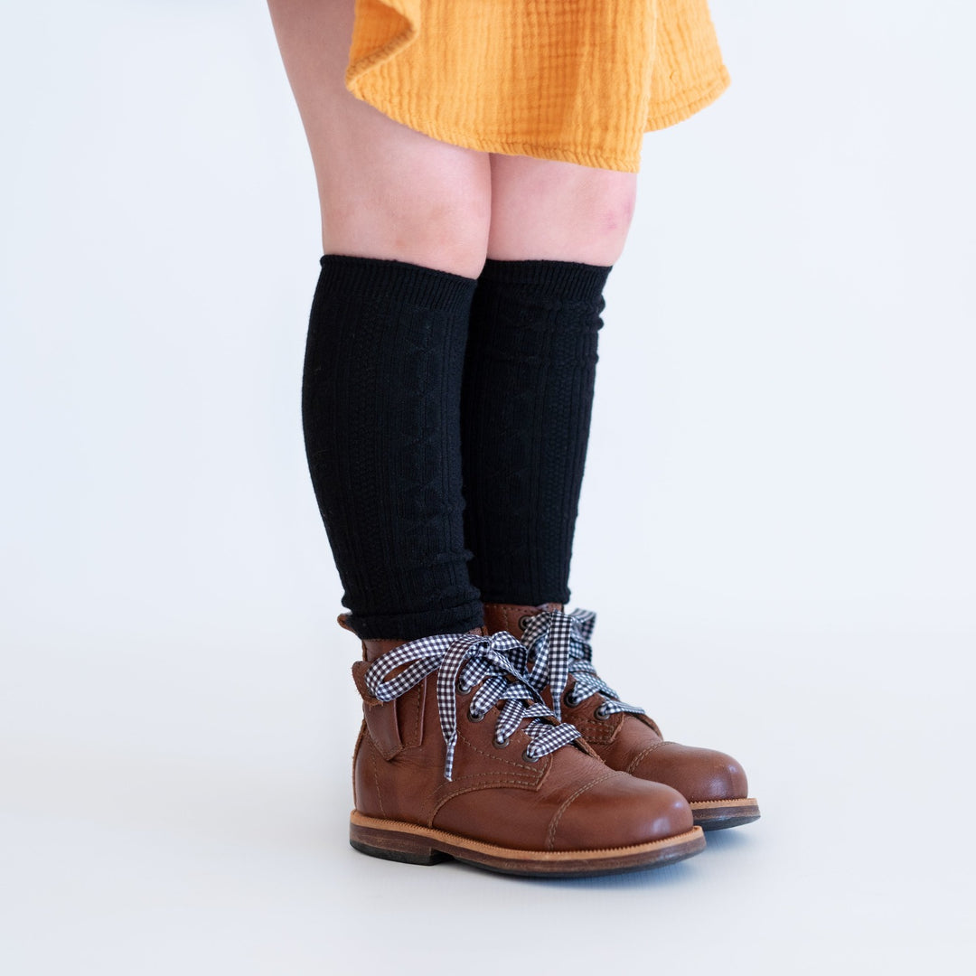 Black knee high socks on little girl.
