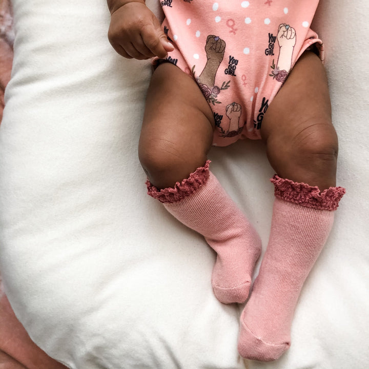 Baby knee high socks with lace trim.