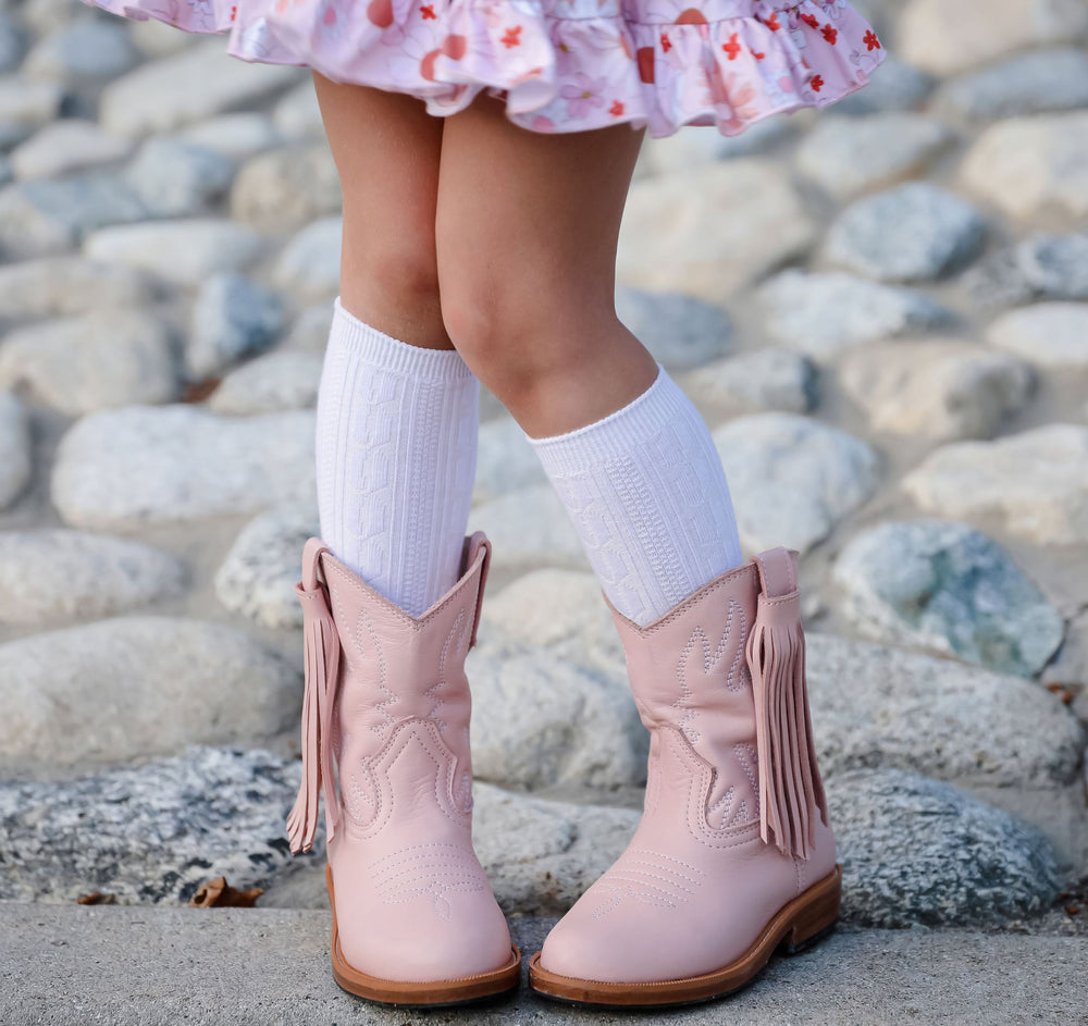 white cable knit knee high socks under pink leather cowgirl boots
