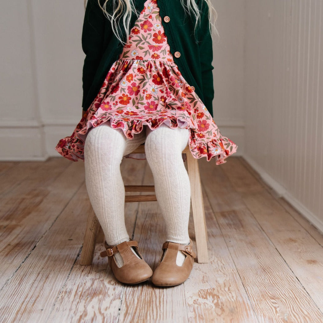 littlegirl in pink floral dress wearing heathered ivory tights