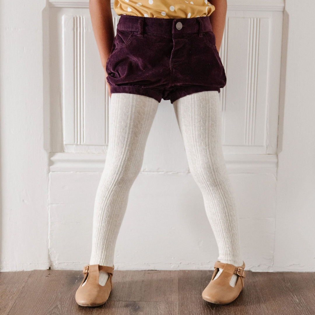 heathered ivory tights under maroon shorts