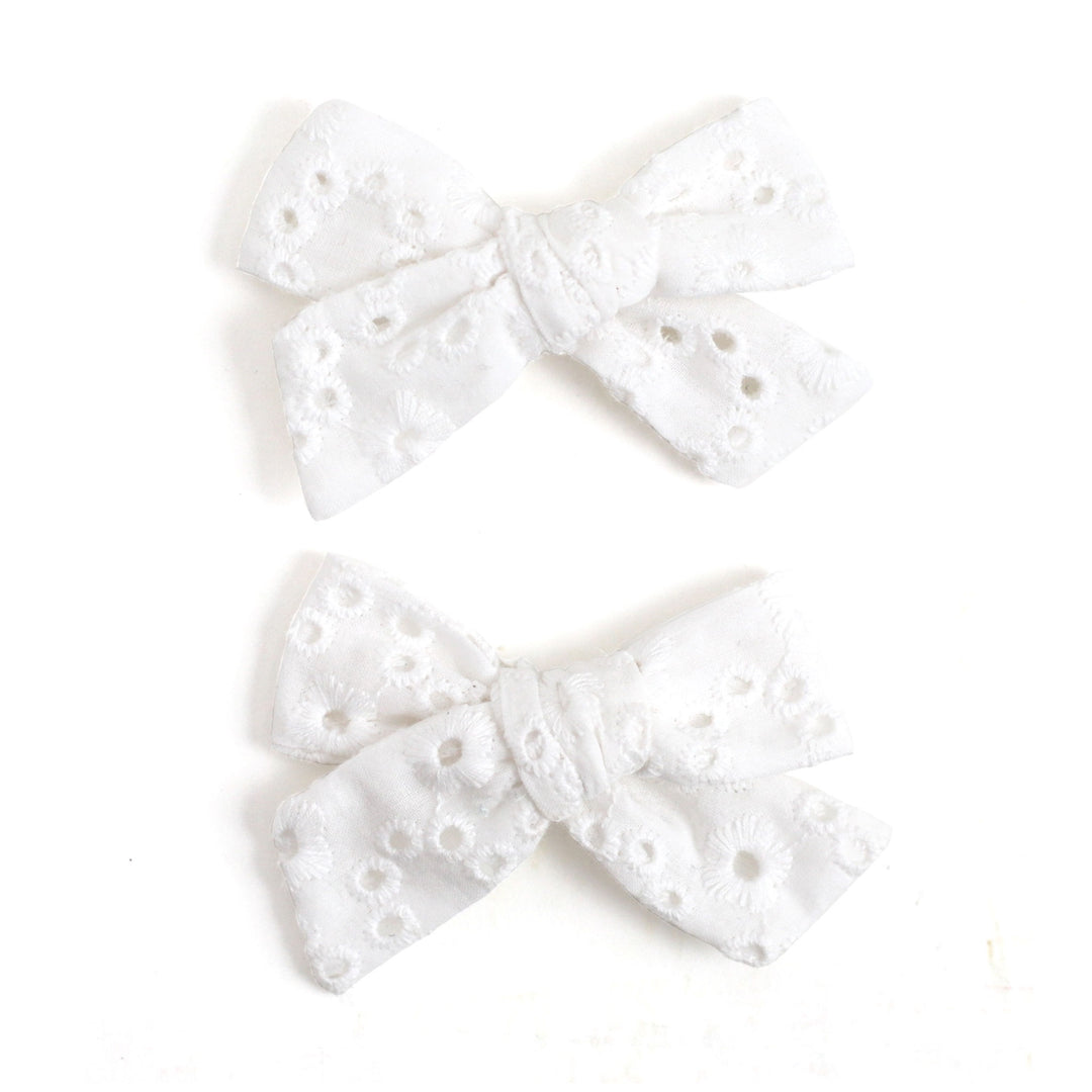 white eyelet fabric piggie bows on clips. cute white hair bows for girls
