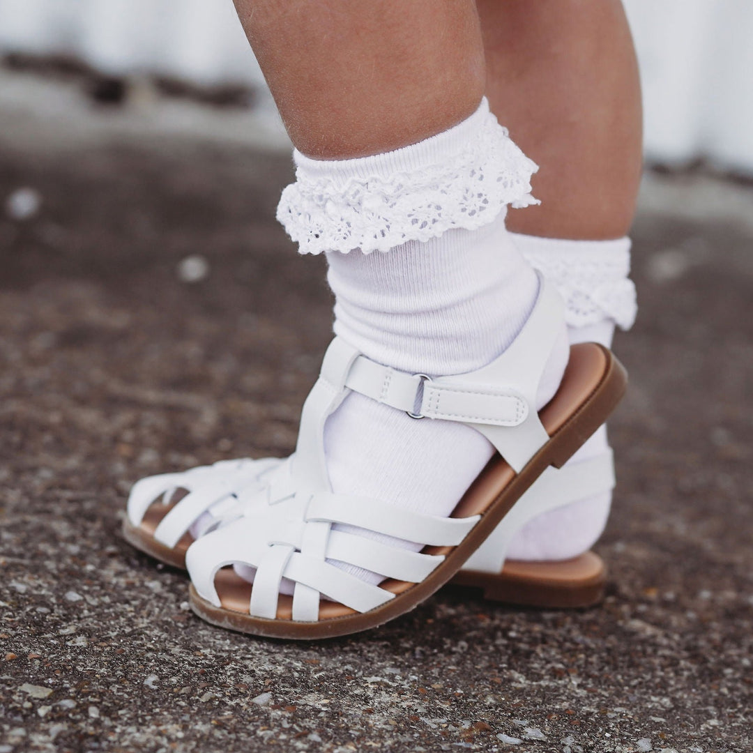 white lace midi socks for babies, toddlers and little girls. shown here with white sandals for spring